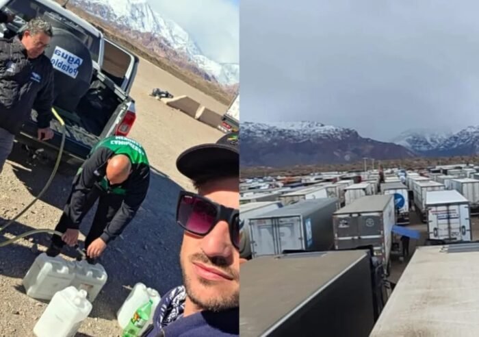 Caminhões estacionados ao lado de grande acúmulo de neve na Cordilheira dos Andes